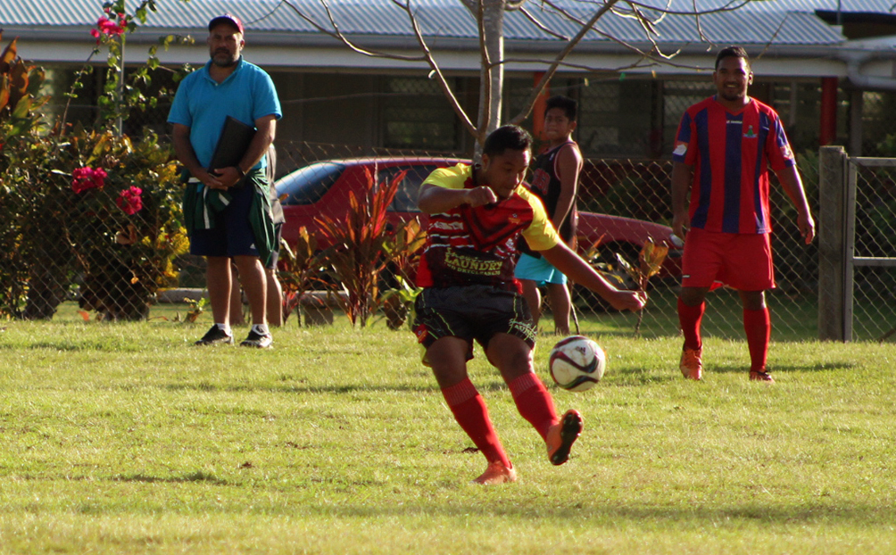 Anthony Samuela of Puaikura clears the ball from his opponent