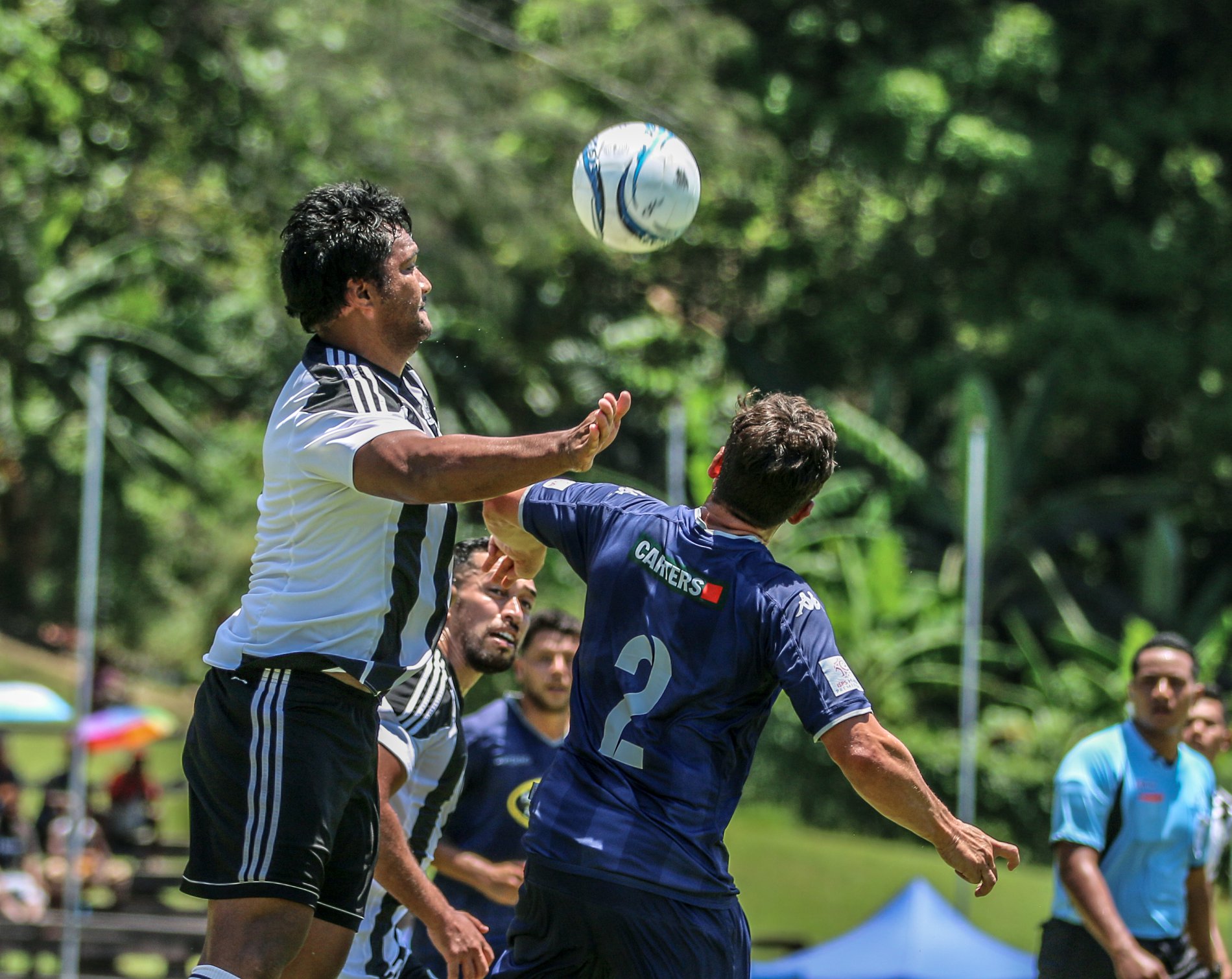 Tupapa captain Mii JOSEPH headers the ball forward for a Tupapa counter