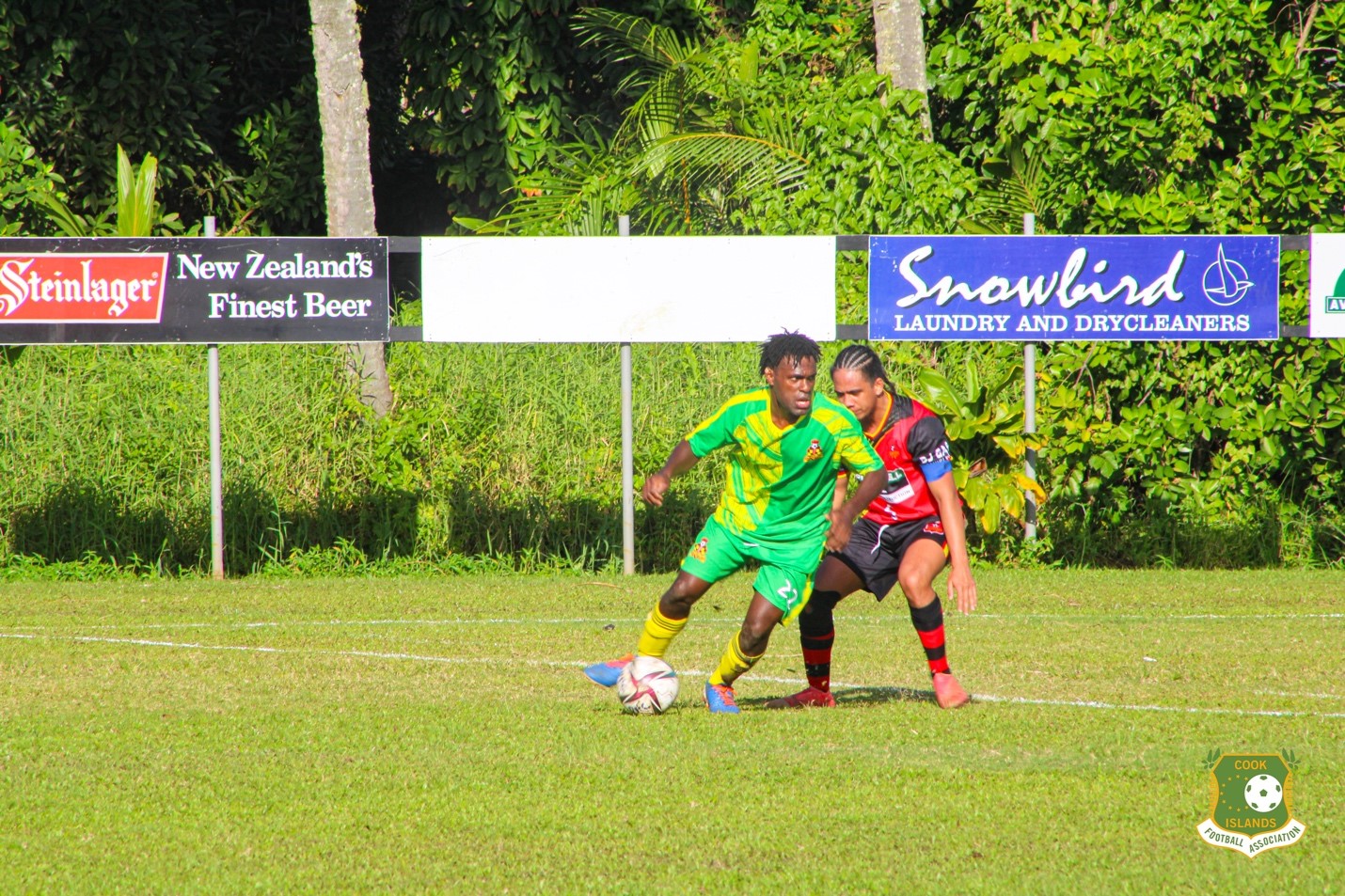 Nikao’s Julius David tries to get ball pass Puaikura’s Jarves Aperau